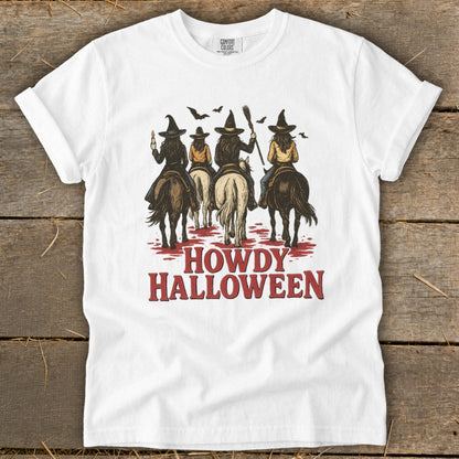 White t-shirt with witches on horses and "Howdy Halloween" text.