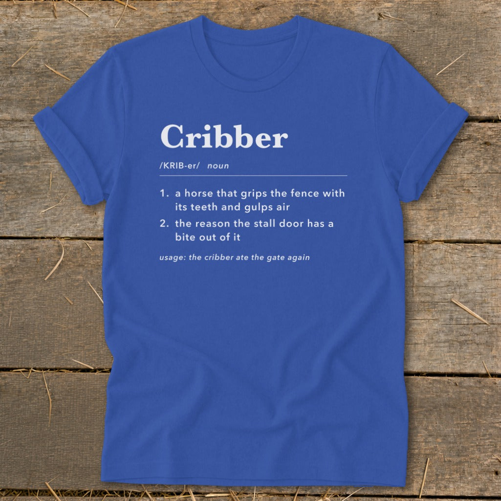 A royal blue t-shirt printed with a humorous dictionary-style definition of the word cribber.