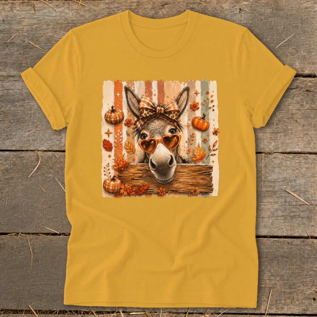 Donkey wearing heart sunglasses and a bow on a fall-themed shirt.