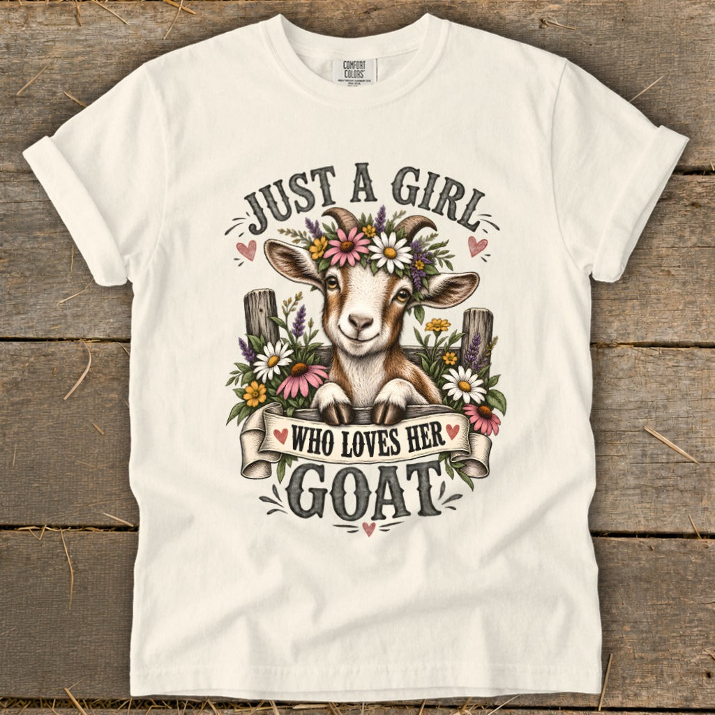 White t-shirt with a goat wearing a flower crown and the text "Just a girl who loves her goat".