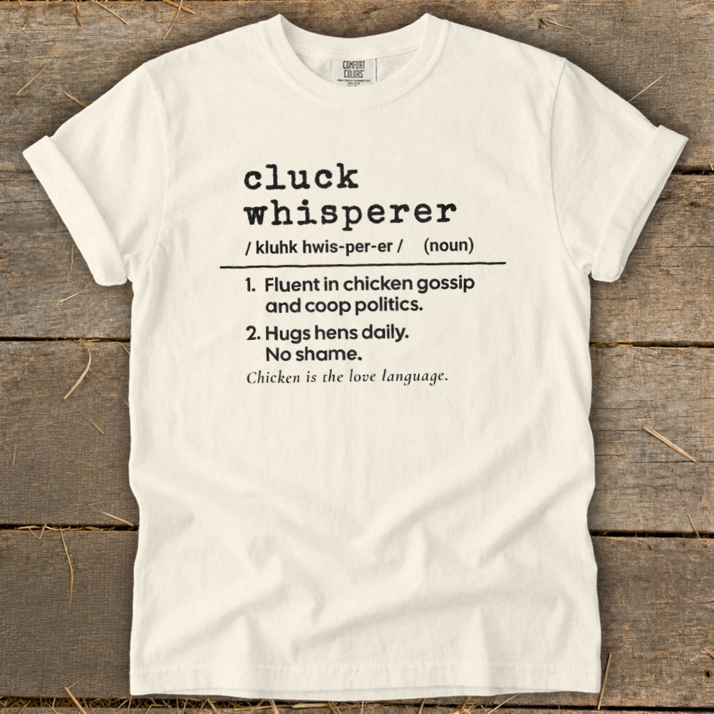 White t-shirt with "cluck whisperer" definition and chicken love language text.