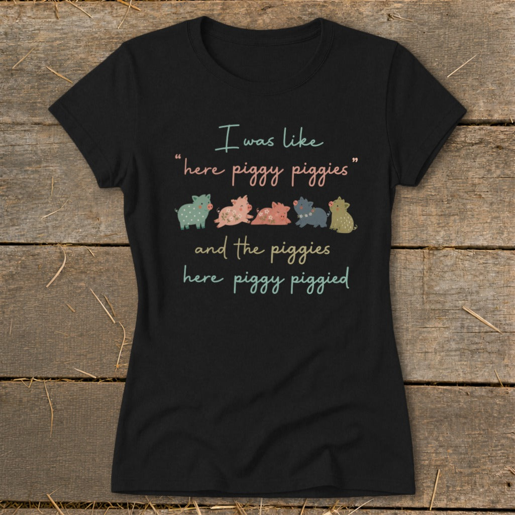 Black t-shirt with colorful pigs and "I was like 'here piggy piggies' and the piggies here piggy piggied" text.