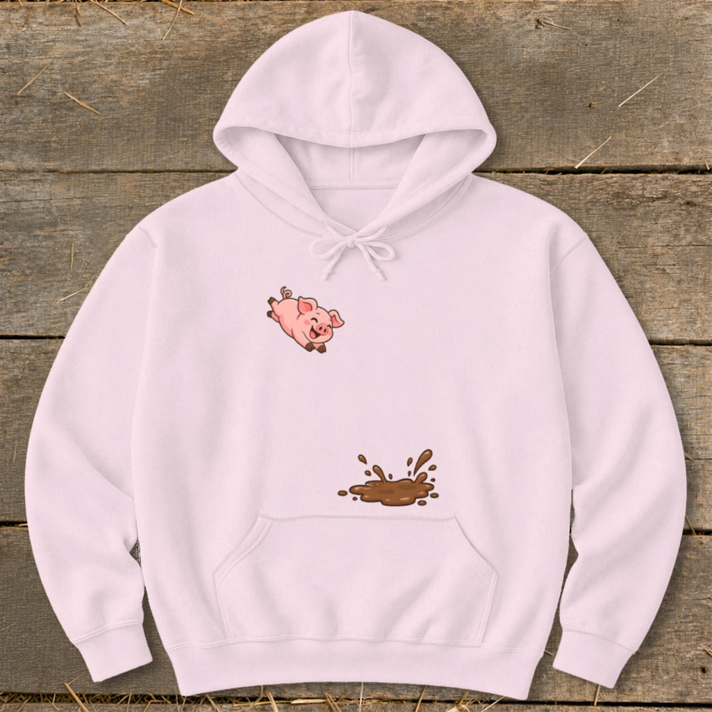 Pink hoodie with a cartoon pig jumping above a mud puddle graphic.