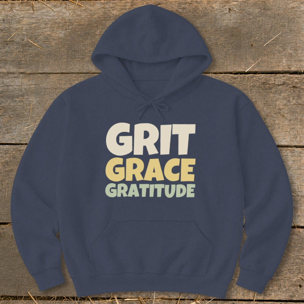 Navy blue hooded sweatshirt laid flat with the text "GRIT GRACE GRATITUDE" printed in the center.