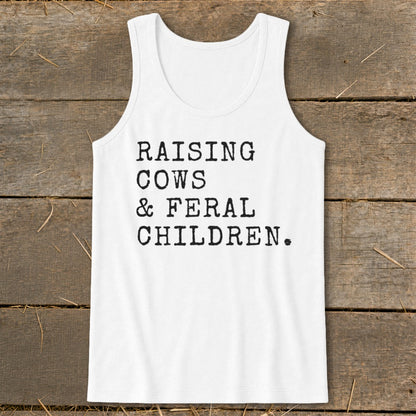 White tank top with "Raising Cows & Feral Children." text in black typewriter font.