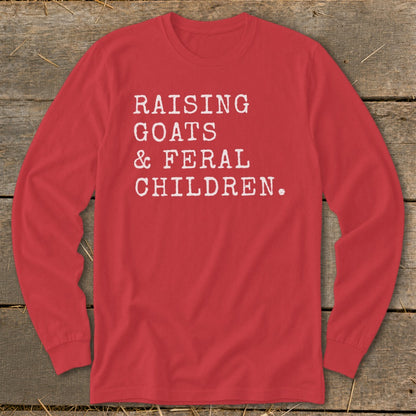 Red long-sleeve shirt with white text "RAISING GOATS & FERAL CHILDREN."