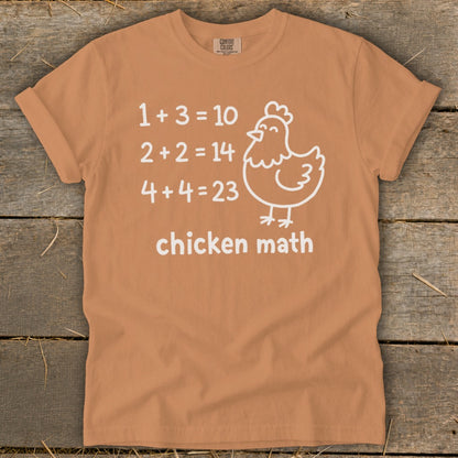 Orange t-shirt with chicken math equations and a cartoon chicken.