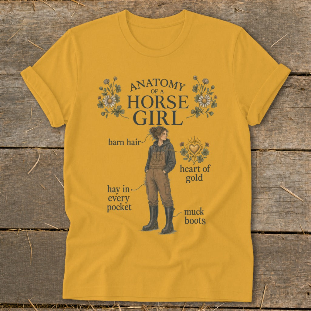 Yellow t-shirt with "Anatomy of a Horse Girl" graphic showing a girl with barn hair, hay in pockets, muck boots, and heart of gold.