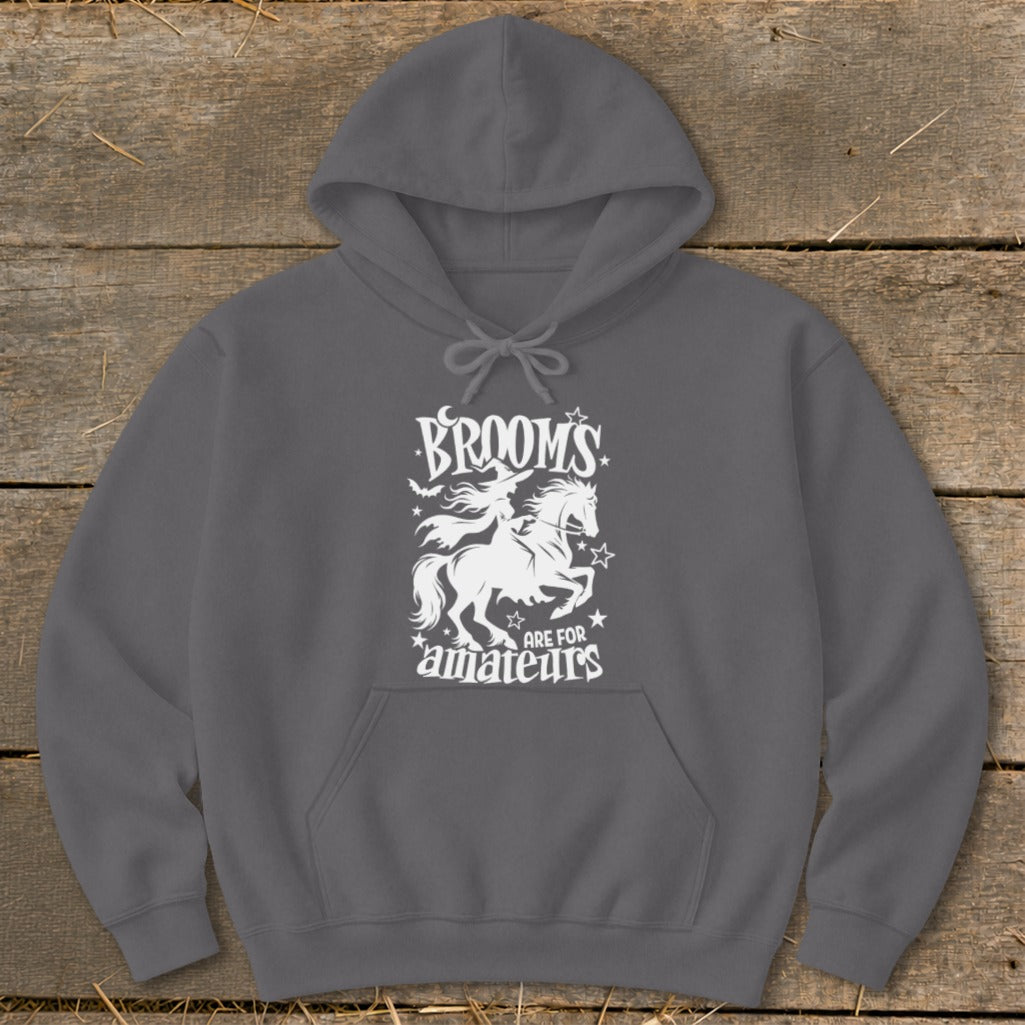 Dark gray hoodie with white graphic of a witch on a horse and the text "BROOMS ARE FOR AMATEURS".