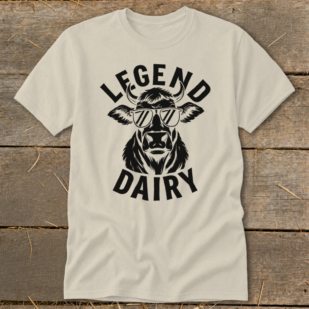 Cream t-shirt with a black graphic of a cow wearing sunglasses, text "LEGEND DAIRY".