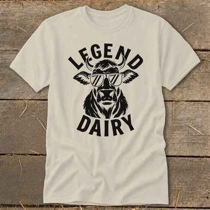 Cream t-shirt with a black graphic of a cow wearing sunglasses, text "LEGEND DAIRY".