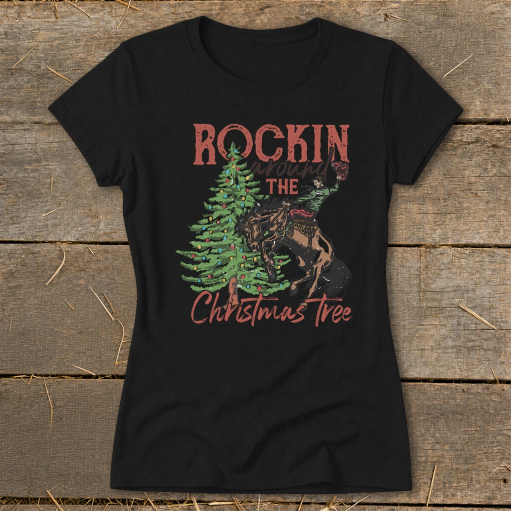 Black t-shirt with "Rockin' Around The Christmas Tree" text and rodeo cowboy illustration.
