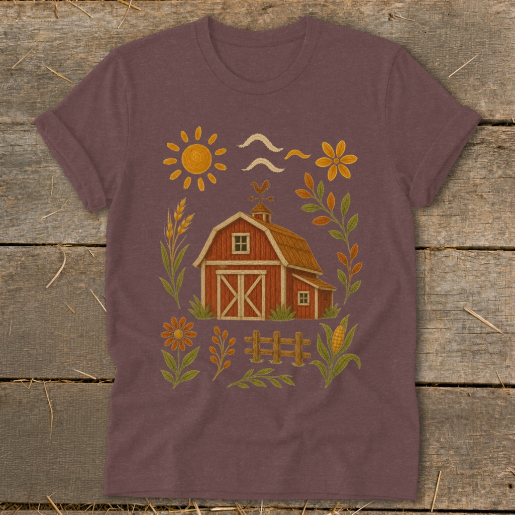 T-shirt with a red barn, sun, flowers, and farm elements.