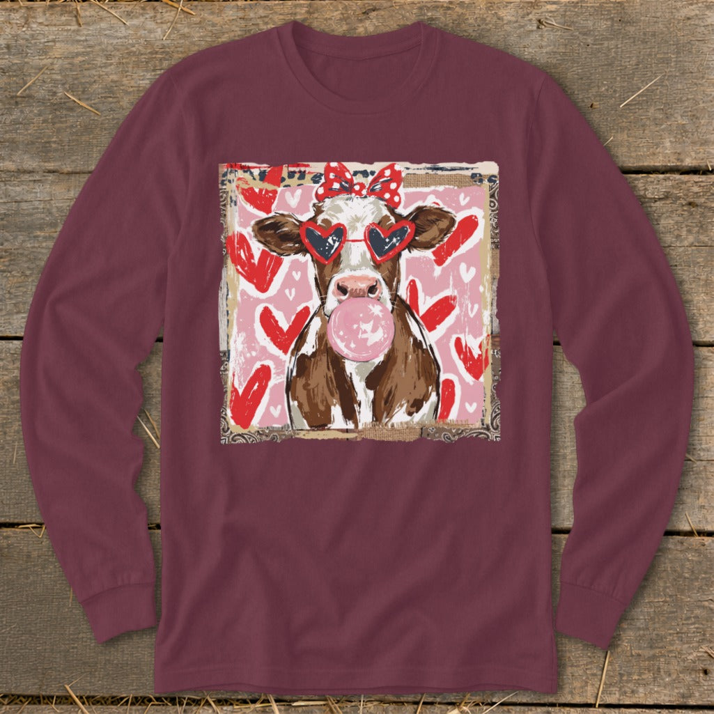 Cow with heart sunglasses blowing bubblegum, on pink background with hearts.
