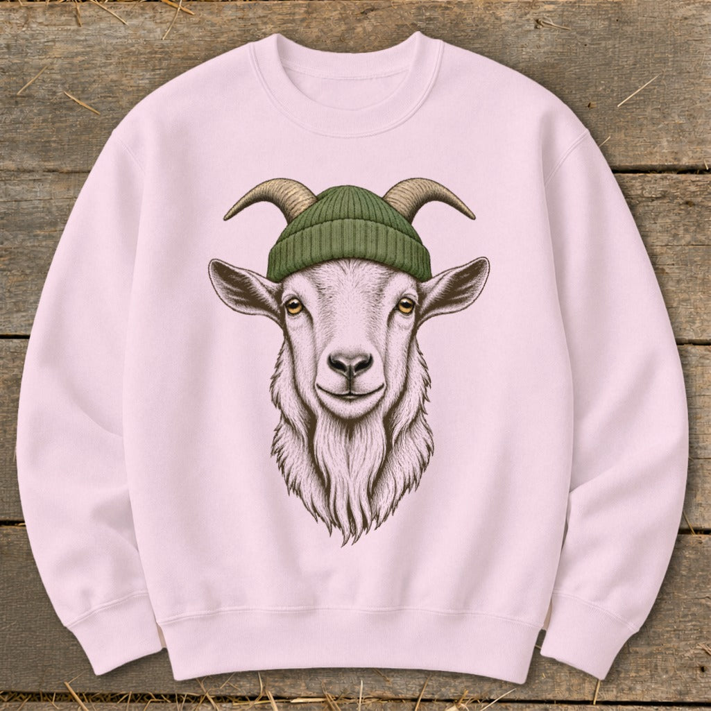 Pink sweatshirt with a detailed drawing of a goat wearing a green beanie.