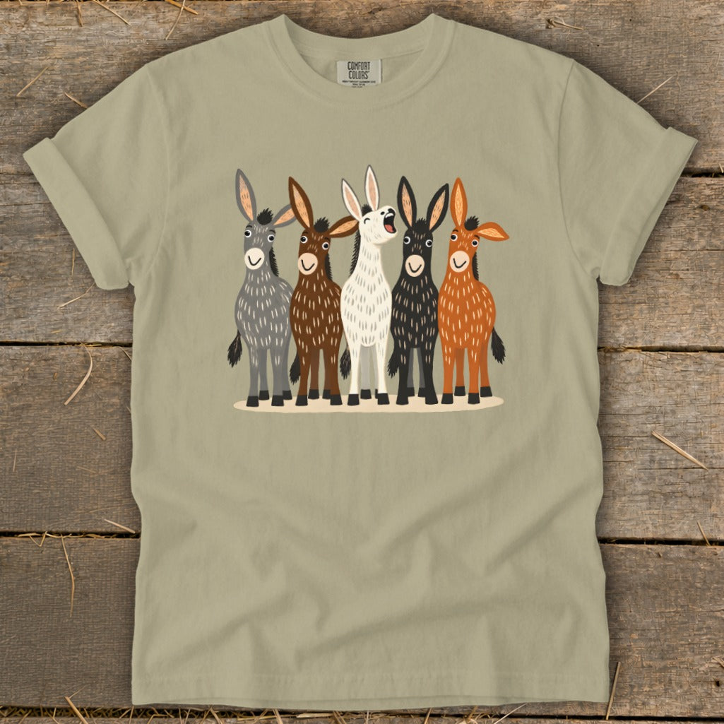 Olive green t-shirt featuring a cartoon illustration of five donkeys in various colors standing side-by-side.