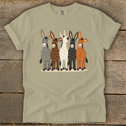 Olive green t-shirt featuring a cartoon illustration of five donkeys in various colors standing side-by-side.