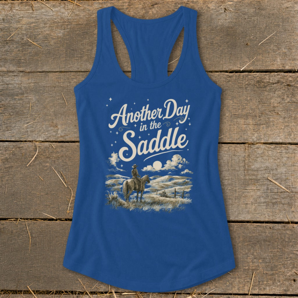 Blue tank top with "Another Day in the Saddle" text and cowboy on horseback.