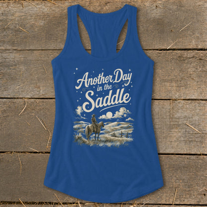 Blue tank top with "Another Day in the Saddle" text and cowboy on horseback.