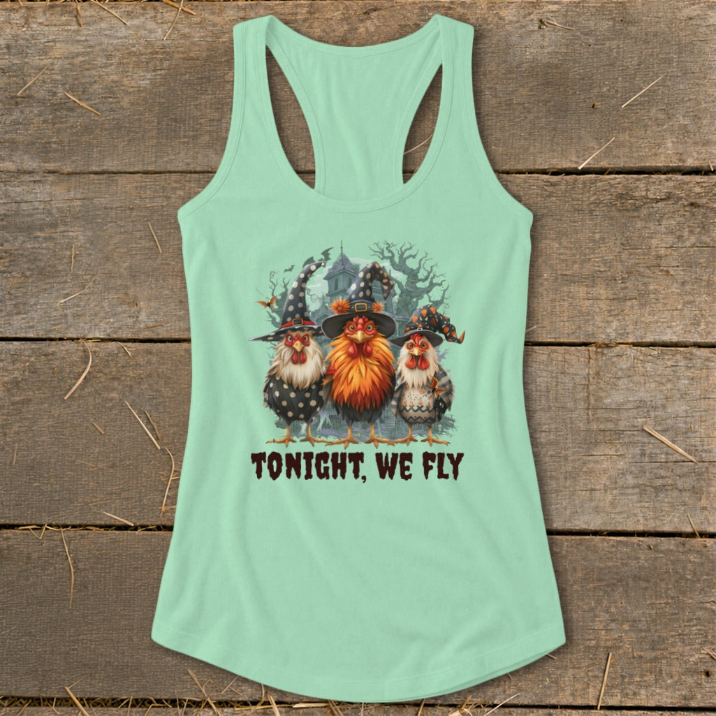 Three chickens in witch hats stand before a spooky house, reading "Tonight, We Fly."