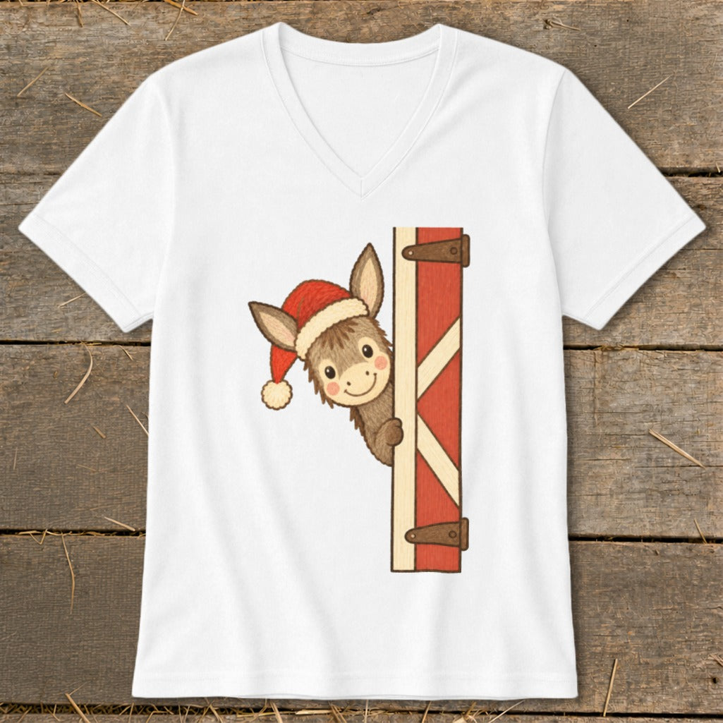 White t-shirt with a cartoon donkey wearing a Santa hat peeking from behind a barn door.