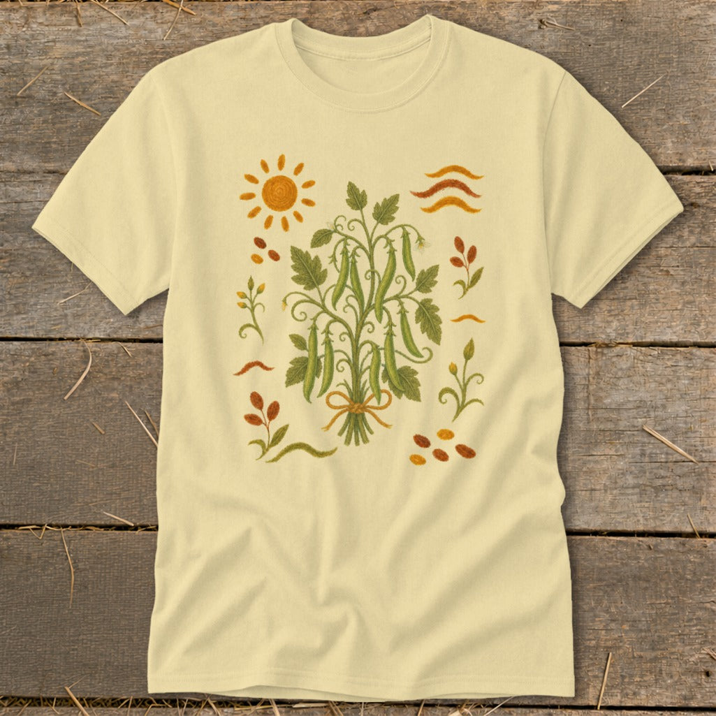 Light yellow t-shirt with embroidered pea pods, sun, and autumn leaves design.