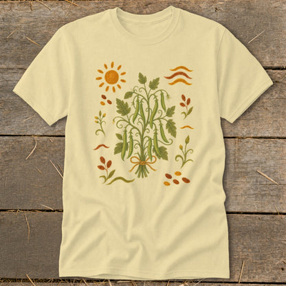 Light yellow t-shirt with embroidered pea pods, sun, and autumn leaves design.