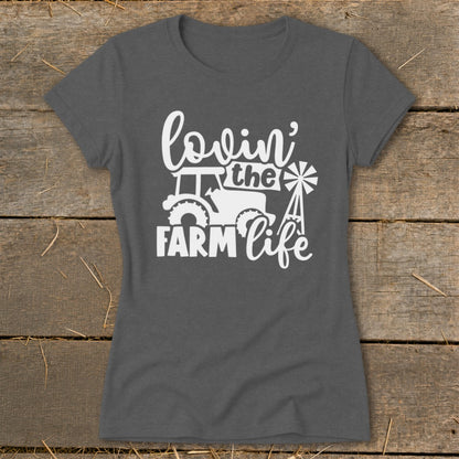 Dark gray t-shirt with white text and graphics: "lovin' the FARM life" with tractor and windmill.