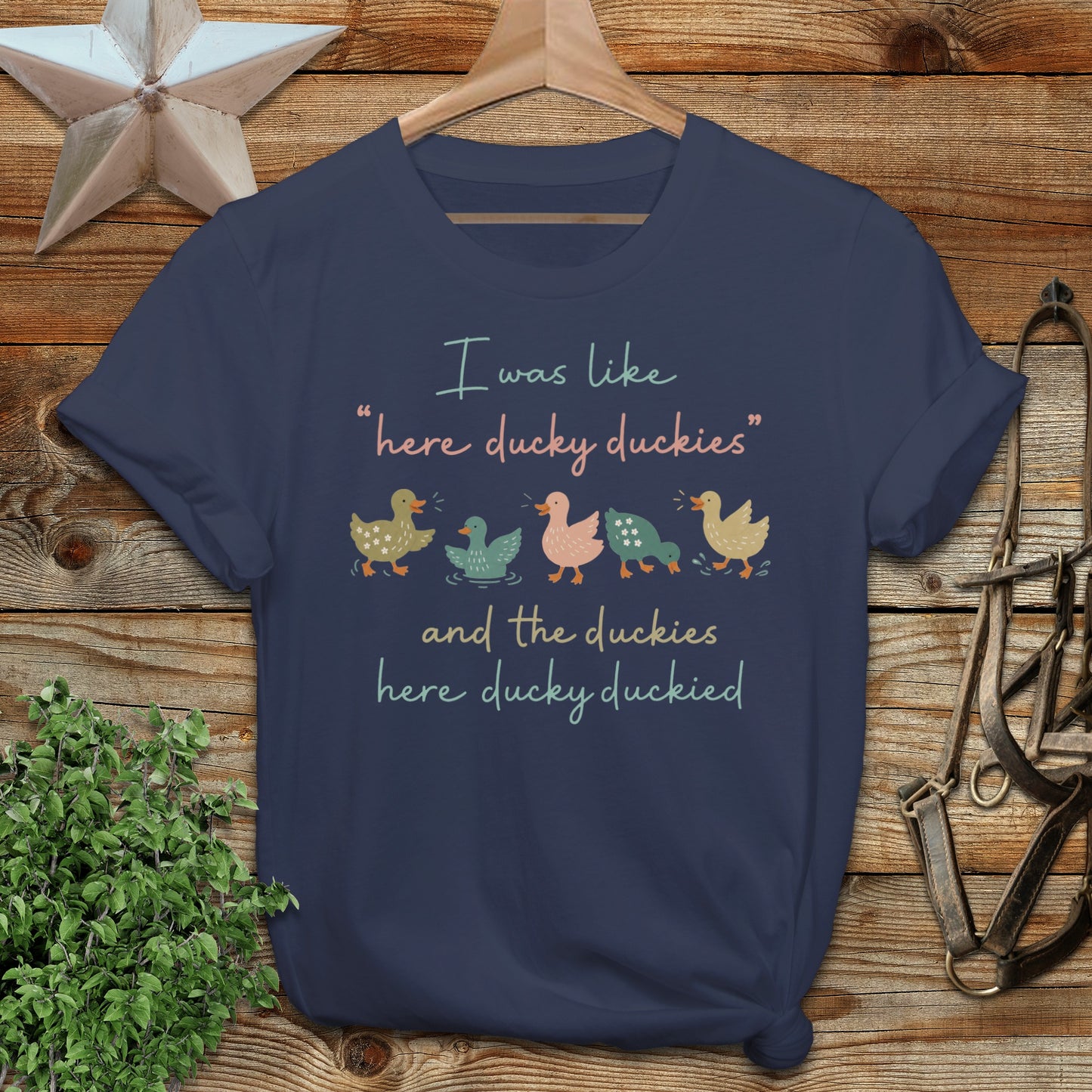 Navy t-shirt with "here ducky duckies" and "here ducky ducked" text and duck illustrations.