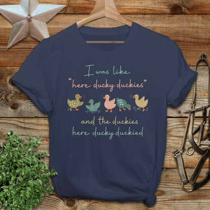 Navy t-shirt with "here ducky duckies" and "here ducky ducked" text and duck illustrations.