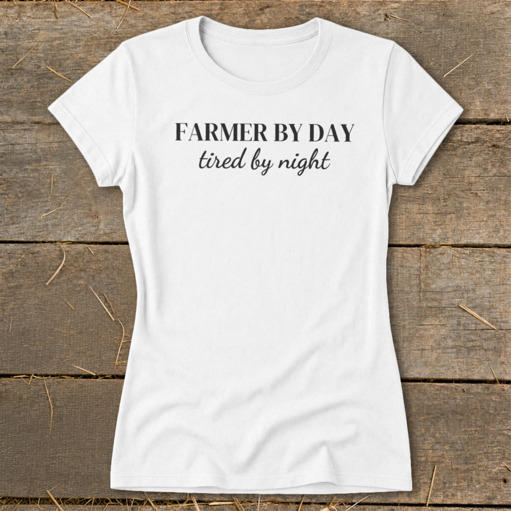 White t-shirt with black text reading "FARMER BY DAY tired by night".