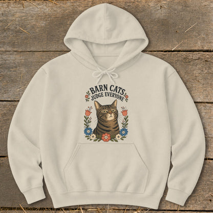 Cream hoodie with a graphic of a tabby cat surrounded by flowers and text reading "Barn Cats Judge Everyone".