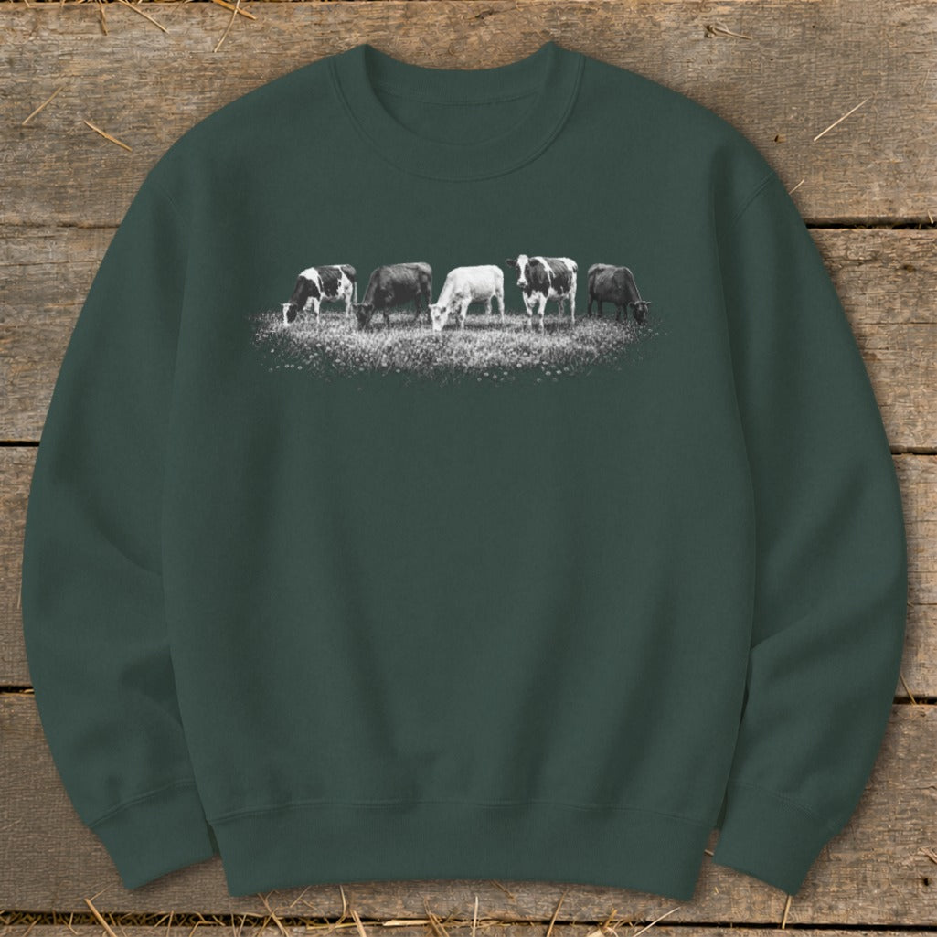 Crewneck sweatshirt with a graphic of five cows grazing in a field.