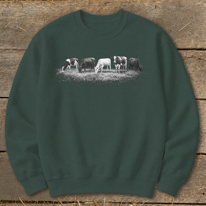 Crewneck sweatshirt with a graphic of five cows grazing in a field.