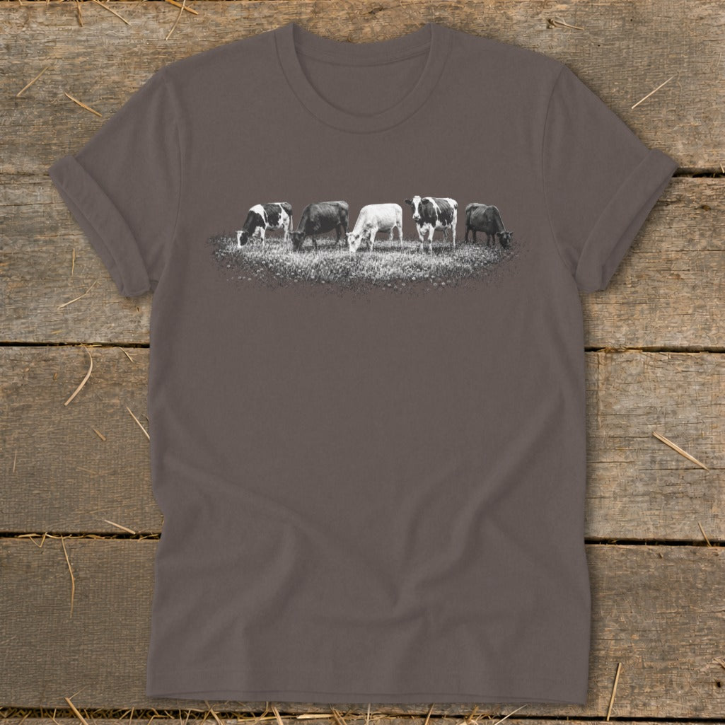 T-shirt with a graphic of five cows grazing in a field.