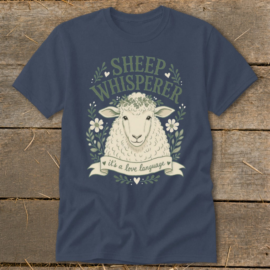 Dark blue t-shirt with a sheep illustration, "SHEEP WHISPERER" text, and "it's a love language" banner.