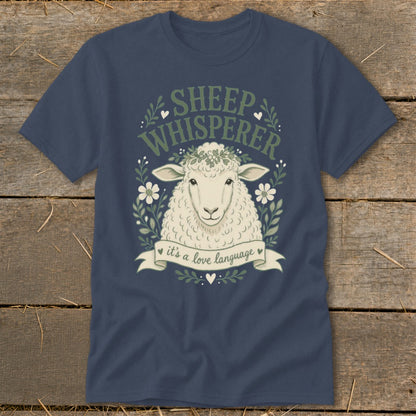 Dark blue t-shirt with a sheep illustration, "SHEEP WHISPERER" text, and "it's a love language" banner.