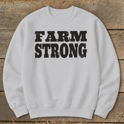 Light gray crewneck sweatshirt featuring the black distressed text FARM STRONG centered on the chest.