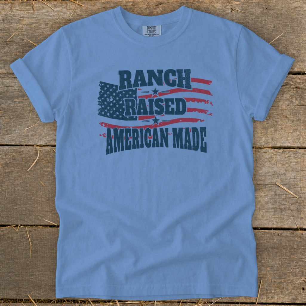 Light blue t-shirt with American flag graphic and text "Ranch Raised American Made".
