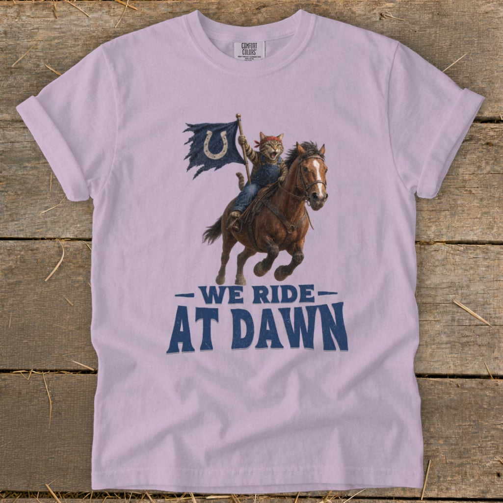 Cat in overalls riding horse with flag, text "WE RIDE AT DAWN".