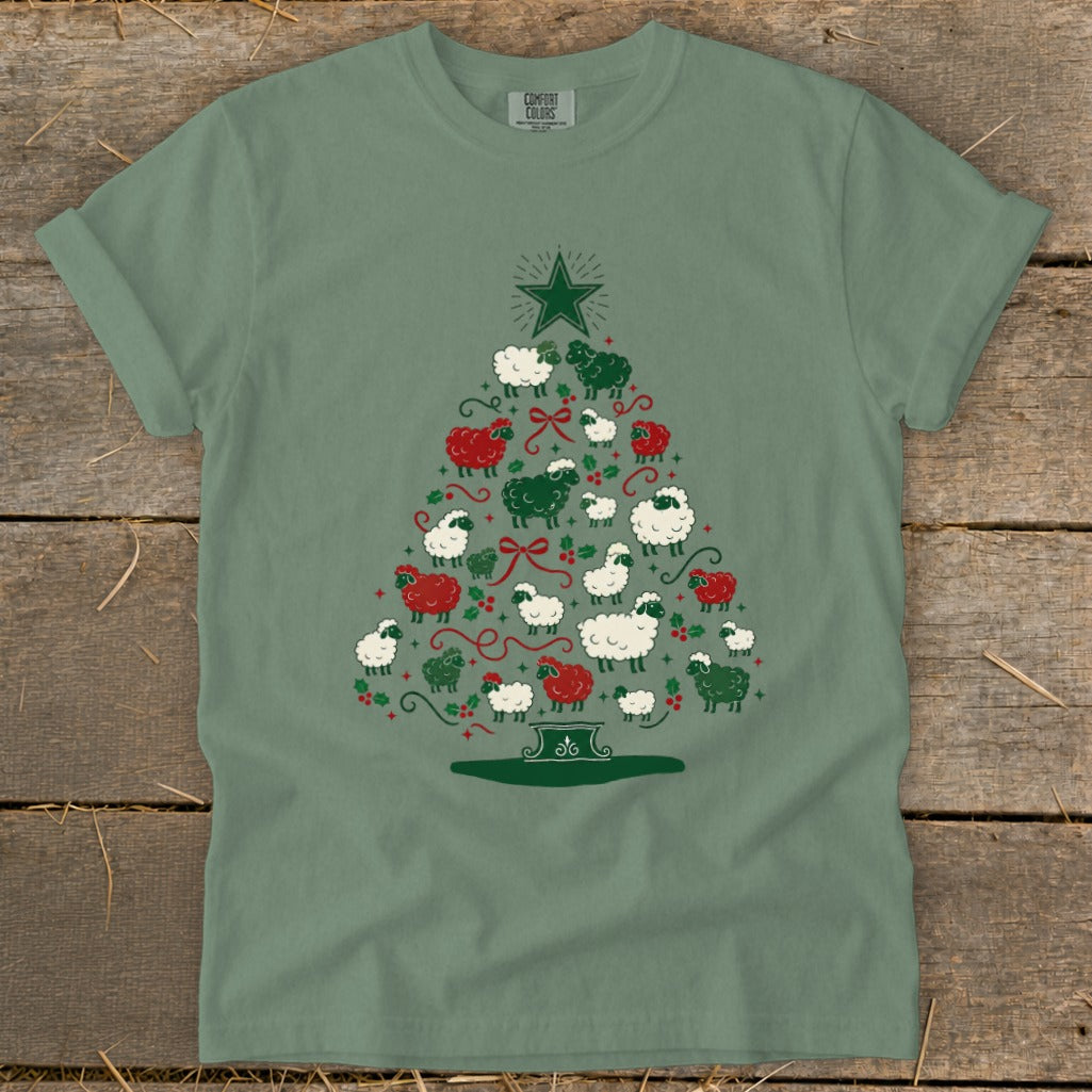Green t-shirt with Christmas tree design made of sheep and holly.