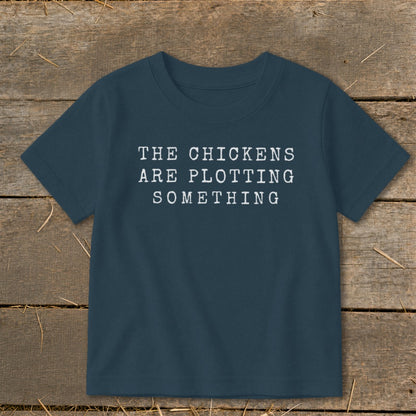 Dark blue t-shirt with white text "THE CHICKENS ARE PLOTTING SOMETHING".