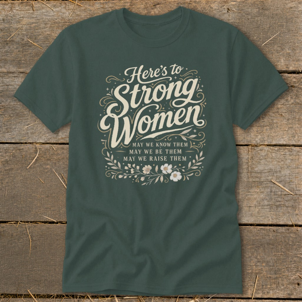 Dark green t-shirt with "Here's to Strong Women" and empowering text.
