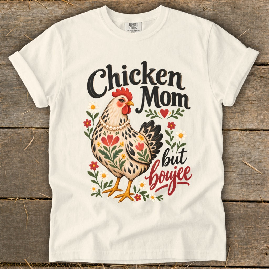 Chicken Mom but boujee text with illustrated chicken and flowers on a cream t-shirt.