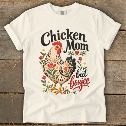 Chicken Mom but boujee text with illustrated chicken and flowers on a cream t-shirt.