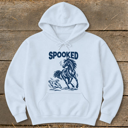 Light blue hoodie with navy "SPOOKED" text and startled horse graphic.
