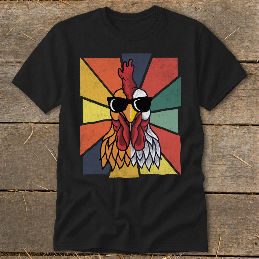 Black t-shirt with a vintage-style rooster wearing sunglasses on a colorful sunburst background.