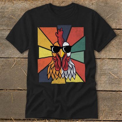 Black t-shirt with a vintage-style rooster wearing sunglasses on a colorful sunburst background.