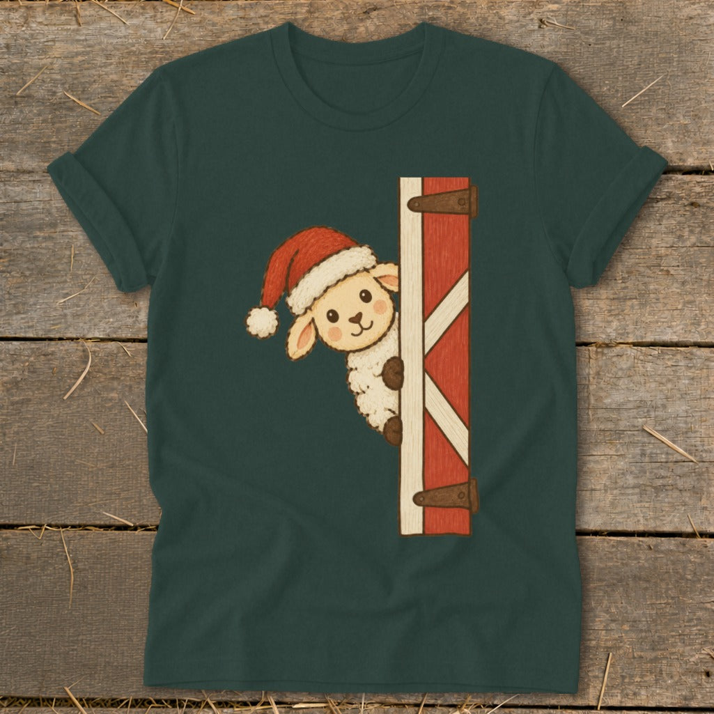 Sheep wearing a Santa hat peeks around a red barn door graphic on a dark green t-shirt.