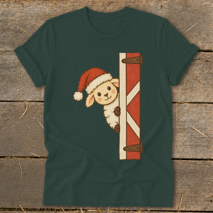 Sheep wearing a Santa hat peeks around a red barn door graphic on a dark green t-shirt.